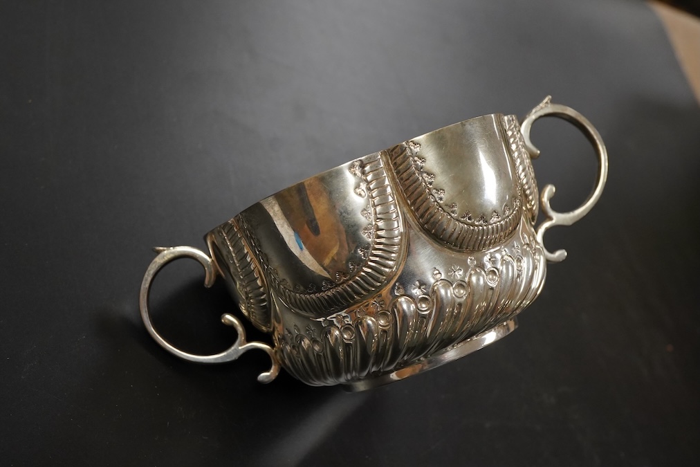 A late Victorian silver twin handled porringer in ealry 18th century style hanlded to handle 17cm., weight approx. 6.48ozt